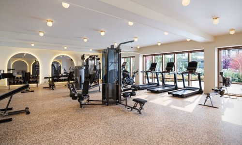 fitness center with open spaces and bright lighting through the windows